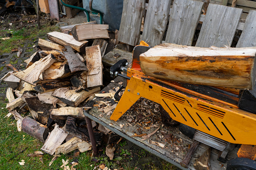 pile of firewood with a log splitter in the garden