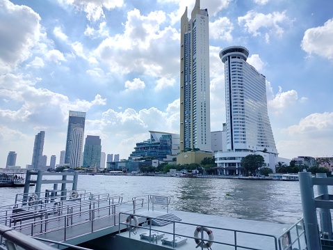 Chao Phraya River, Bangkok, Thailand - March 26th 2023: Modern high rise buildings at the brink of the river which runs through the capital of Thailand