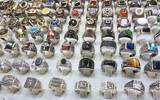 Closeup of various silver rings with diamonds