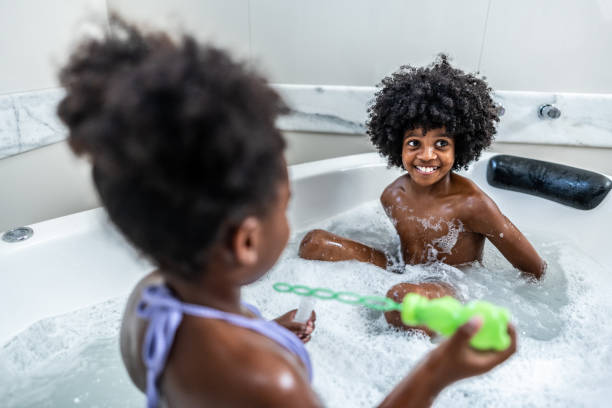 istock Child boy playing with sister on bathtub at home 2004934396