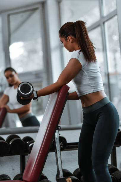istock Dumbbell Workout Day For Female Athlete In Gym 2004948433