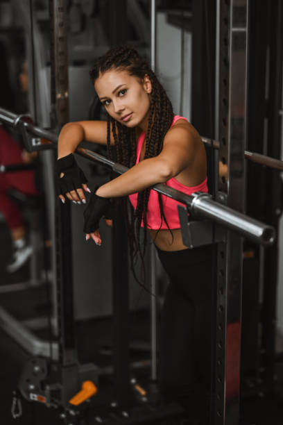 istock Female Getting Ready For Squats Exercise With Bar In Gym 2004949005