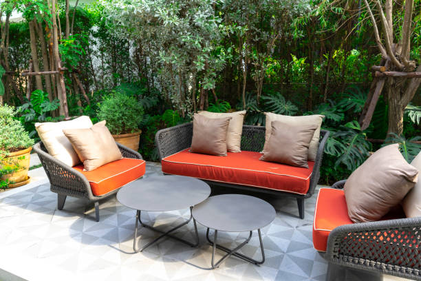 istock Backyard outdoor garden patio with modern wicker sofa and pillow. 2004956438