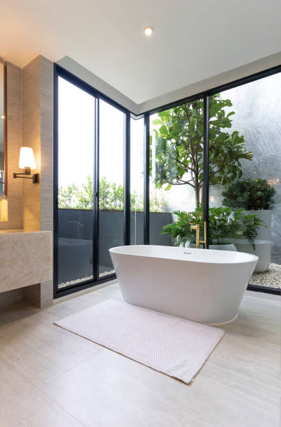 istock Spacious and bright modern bathroom with white bathtub. 2004964089