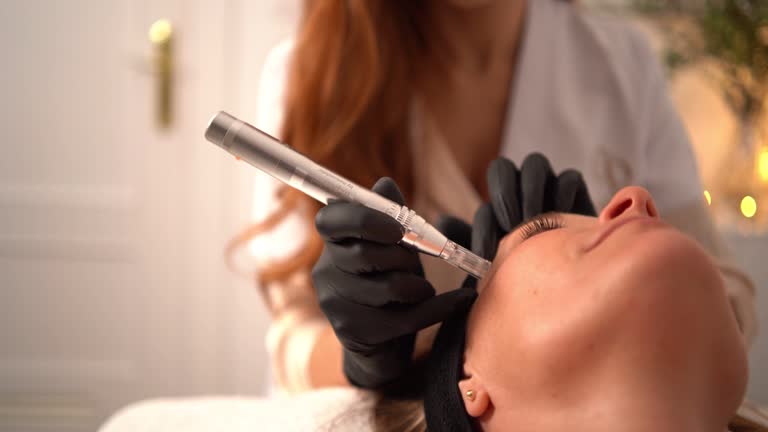 Beautician performing micro-needling collagen treatment