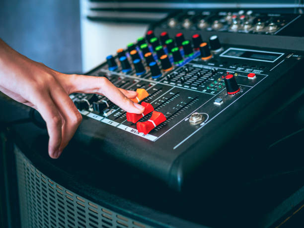 istock Sound engineer hands adjusting control sound mixer in recording, broadcasting studio,Sound mixer. Professional audio mixing console, buttons, faders and sliders. sound check. 2004976460