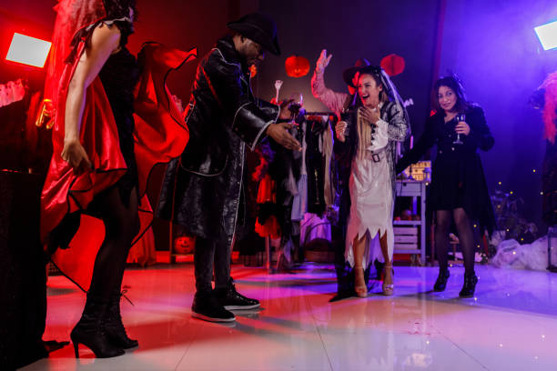 istock Cheerful group of friends dancing during a fun Halloween party 2004979984
