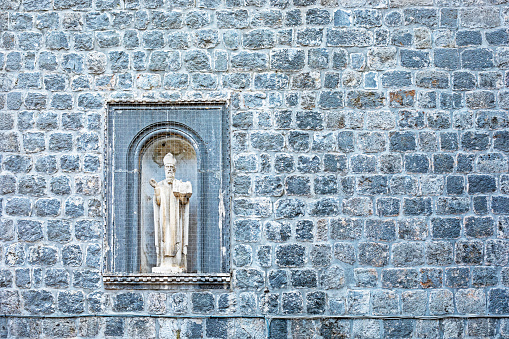 roman masonry gray wall with cat with saint