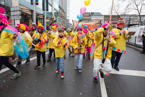 Cologne, Germany - February 11, 2024: On Carnival Sunday in Cologne, there are the traditional parades of schools and societies, Schull- un Veedelszöch)( the participants are usually wearing self made costumes, here a group of Waldorfschule, here the group of the Freie Waldorfschule, they participate with a marching band