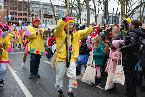 Cologne, Germany - February 11, 2024: On Carnival Sunday in Cologne, there are the traditional parades of schools and societies, Schull- un Veedelszöch, the participants are usually wearing self made costumes, here the group of the Freie Waldorfschule, specators, many children waiting for sweets to be thrown