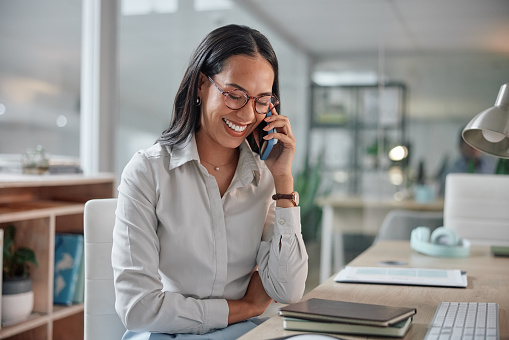 Phone call, laughing and business woman in office for corporate legal project or deal. Smile, communication and professional female attorney work on law case with mobile conversation in workplace.