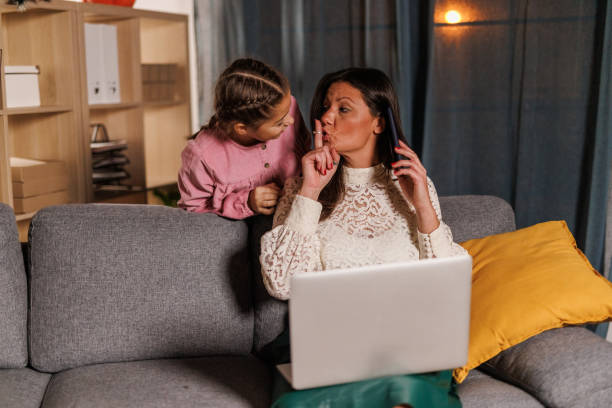 istock Girl interrupting her mother while she is on a conference call 2005016413
