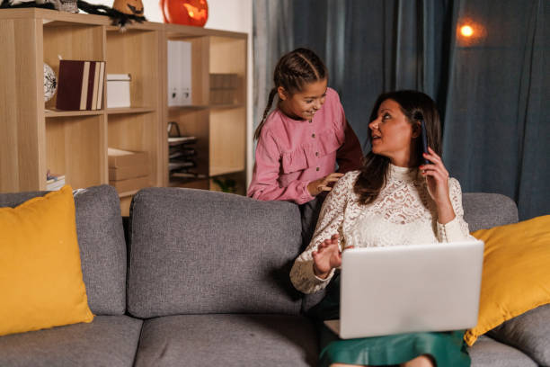 girl interrupting her mother while she is on a conference call - inconvenience meeting business distracted ストックフォトと画像