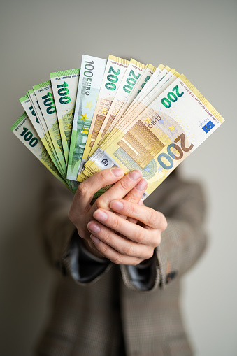 business lady holds euro bills in her hands