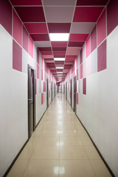 interior perspective of a long corridor with colored geometric lines