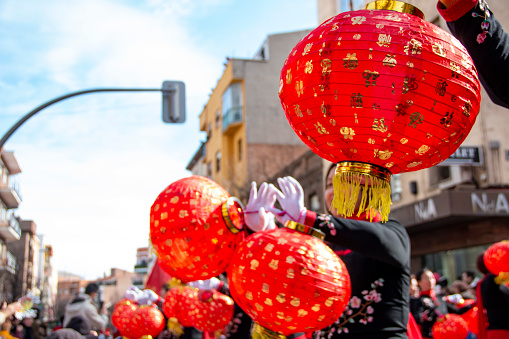Chinese New Year Wooden Dragon Parade. In this case we can see the dance with red balloons carried by Chinese women