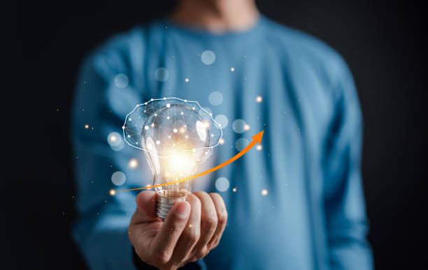 istock Hand man holding illuminated lightbulb, idea, innovation and inspiration with glowing virtual brain, smart intelligent creativity with bulbs, Motivation and innovation concept. 2005050925