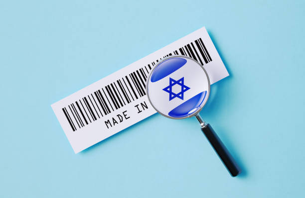 Magnifier and Israeli flag printed barcode label on blue background. Horizontal composition. Made In Israel concept.