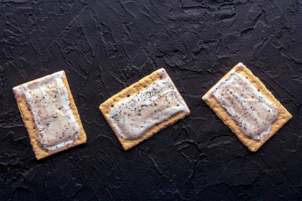 istock Pop tarts. Poptart toaster pastry with icing on a black background, overhead 2005064786