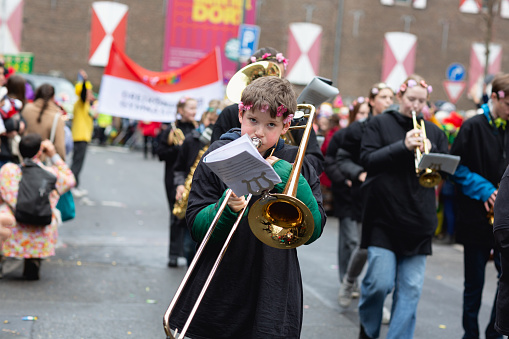 Cologne, Germany - February 11, 2024: On Carnival Sunday in Cologne, there are the traditional parades of schools and societies, Schull- un Veedelszöchthe participants are usually wearing self made costumes, here the marching band of the Dreikönigsgymnasium