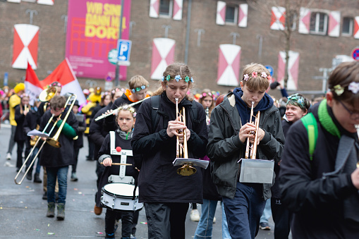 Cologne, Germany - February 11, 2024: On Carnival Sunday in Cologne, there are the traditional parades of schools and societies, Schull- un Veedelszöch the participants are usually wearing self made costumes, here the marching band of the Dreikönigsgymnasium
