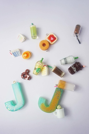 miniature of the letter of the alphabet and cakes on a white background