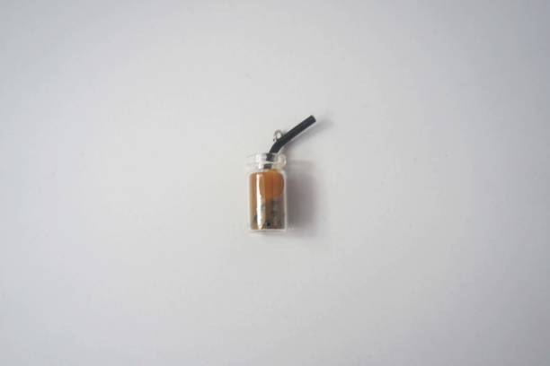 A bottle of miniature chocolate bubble drink on a white background. View from above.