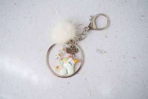 close up of a handmade key chain on a white background
