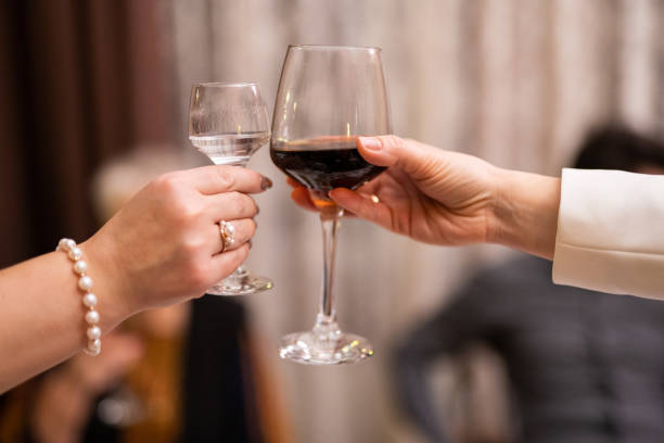 istock clinking glasses with alcoholic drinks in their hands 2005083933