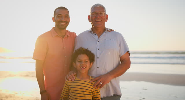 Generations, face and happy on beach together for bonding and holiday vacation by sunset with lens flare. Grandfather, son and grandchild in portrait with smile by ocean and love on travel adventure