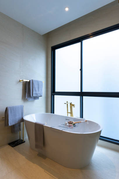 istock Spacious and bright modern bathroom with white bathtub. 2005090928