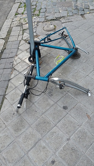 bicycle parked on the street with stolen parts.