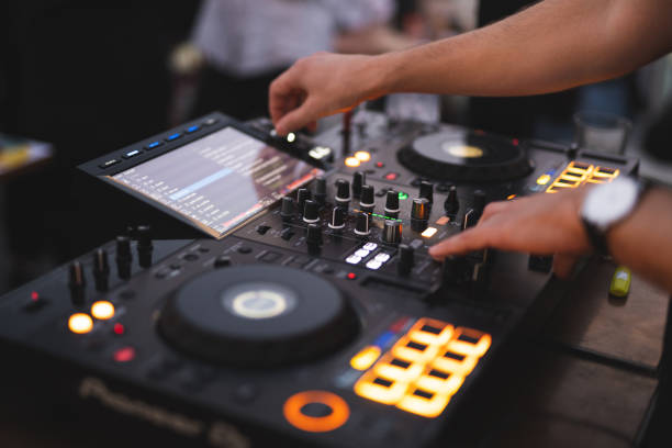 istock a DJ plays music on a controller at a party 2005096966