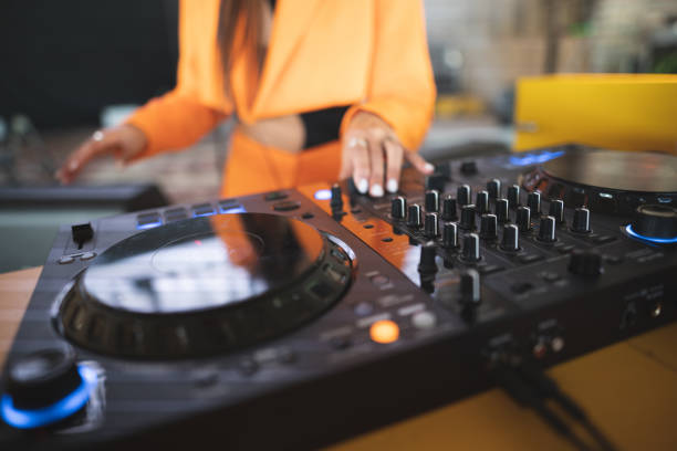 a DJ plays music on a controller at a party