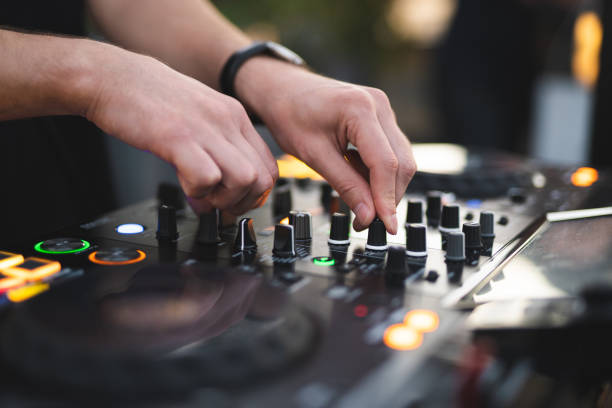 istock a DJ plays music on a controller at a party 2005098108
