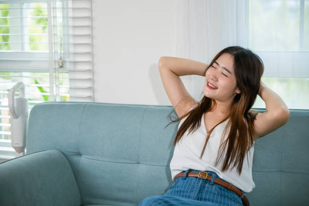 istock woman enjoying free time relaxing put arm hand back behind head 2005100290