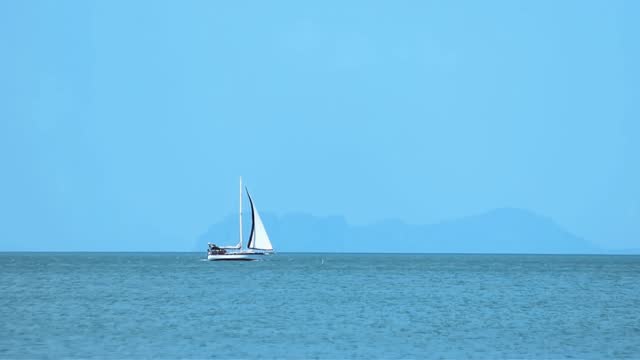 Sailboat in the sea blue sky and sea background