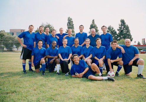 Soccer team celebrating their victory and holding the cup