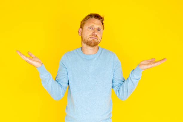 istock Young adult man showing doubt expression over isolated yellow background 2005117830