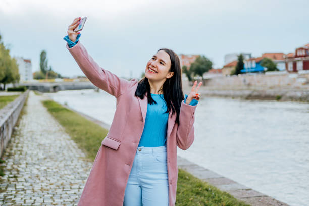 istock Young woman taking selfies on the quayside 2005121157