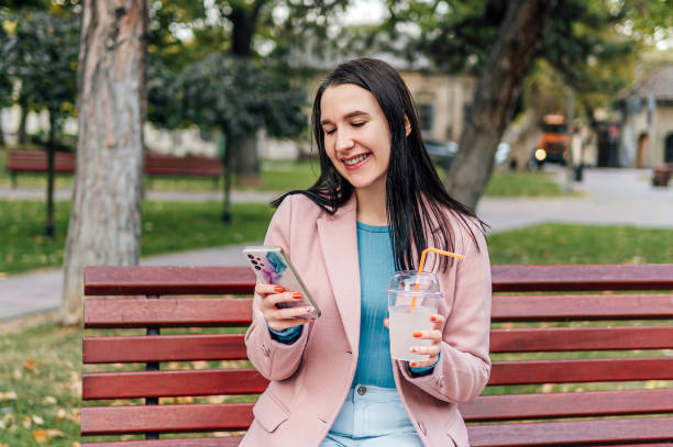istock Woman using phone in the park 2005125528