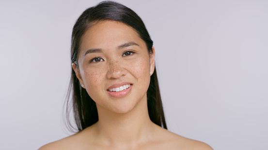 Skincare, portrait and Asian woman in studio for wellness, cosmetics or treatment on white background space. Beauty, mockup and Japanese model face with glowing skin, dermatology or self care results