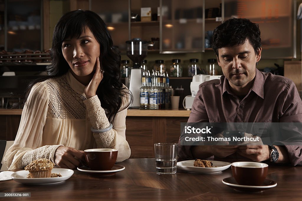 Donna e uomo maturo seduto al tavolo con caffè, uomo - Foto stock royalty-free di 25-29 anni