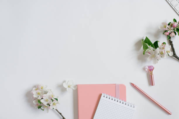 istock Blogger workplace: notebooks with pen and apple flowers on a white background with copy space. Flat lay 2005146030