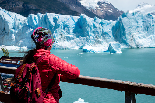 Tourist admiring the greatness of the Perito Moreno glacier in Argentina. Tourist visiting the Perito Moreno glacier in El Calafate, Argentina. Imposing glacier in Patagonia Argentina