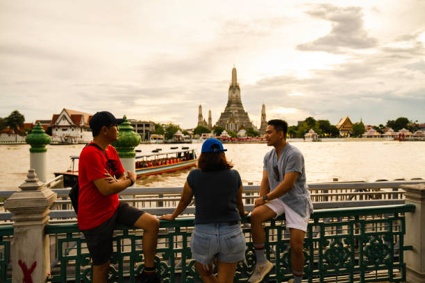 istock private tourist guide explaining the place history to group traveler Exploring with view Wat Arun Temple at sunset in Bangkok, Thailand 2005164111