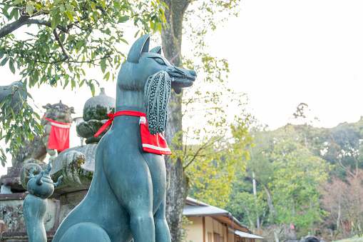 Kyoto, Japan - Jan 3, 2024: Fox statue in Fushimi Inari Taisha Sembon Torii Thousand Torii gates in Kyoto Japan
