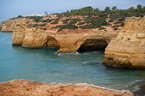 Secluded Beauty, Algarve Coastal Rock Formation Panorama. Cliff, sea, atlantic shore, vacation, hiking, travel destination.