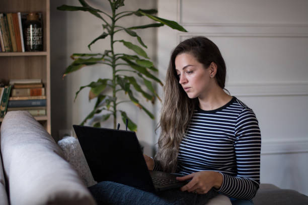 Young female freelancer working from home on her laptop computer.