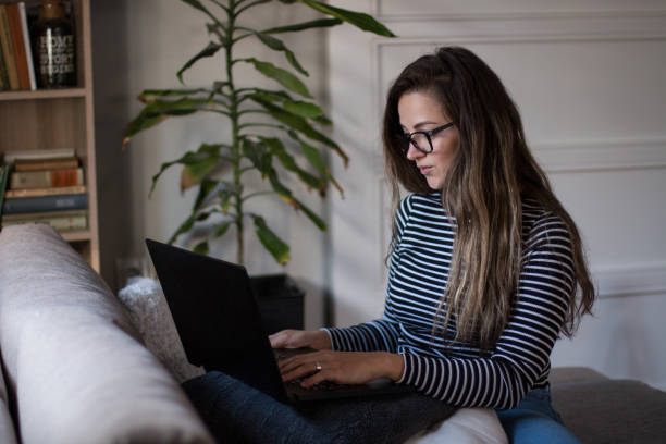 istock Young female freelancer working from home on her laptop computer. 2005187897